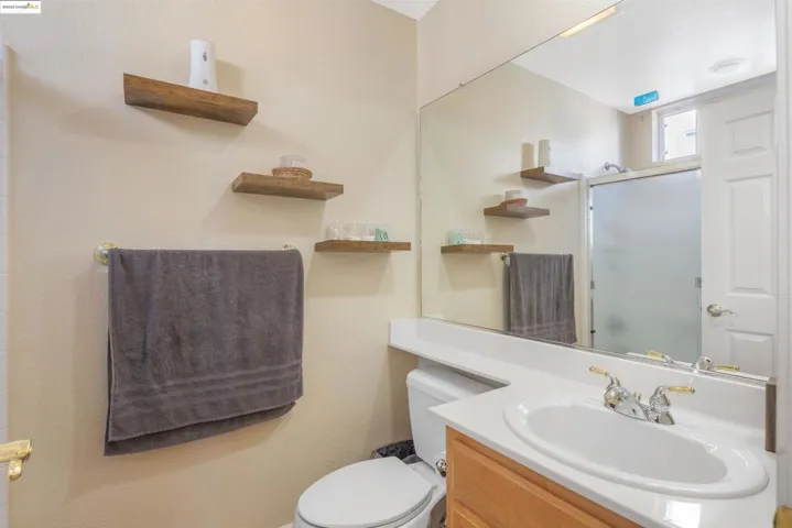 Full bathroom with vanity and a shower stall