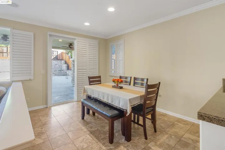 Dining room featuring ornamental molding, recessed lighting, and light tile patterned floors