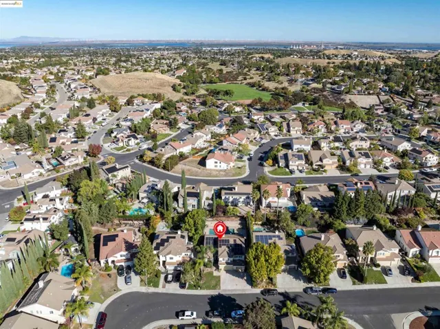 Aerial view of property's location with nearby suburban area