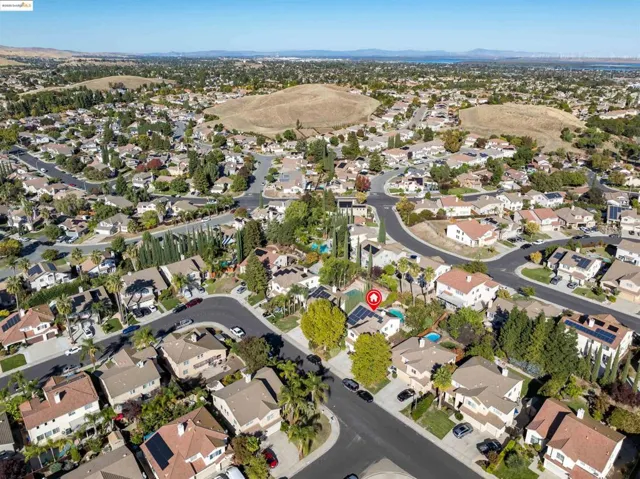 Aerial view of property's location featuring nearby suburban area and mountains