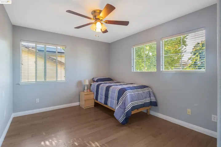 Bedroom with wood finished floors and a ceiling fan
