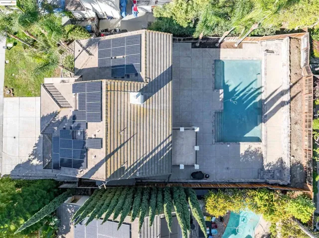 Aerial view of property and surrounding area featuring a pool