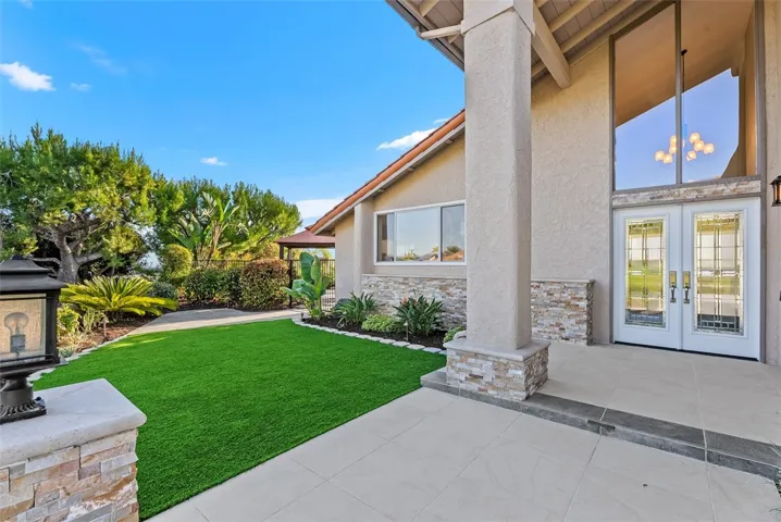 The front-yard enjoys new hardscaping, stone accents, and landscape lighting to provide impressive curb appeal