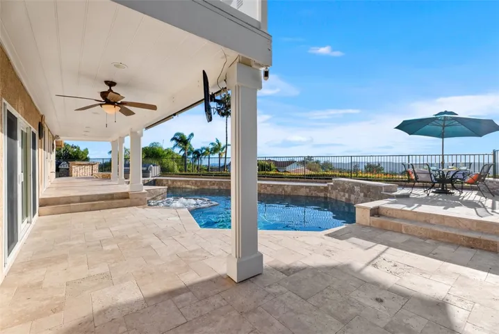 The resort-style backyard offers a saltwater pool and spa with a waterfall feature