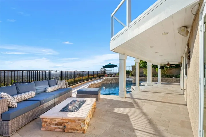 The resort-style backyard offers a saltwater pool and spa with a waterfall feature