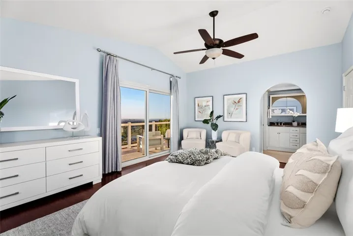 Primary suite features two walk-in closets, an ensuite bathroom, and a private balcony