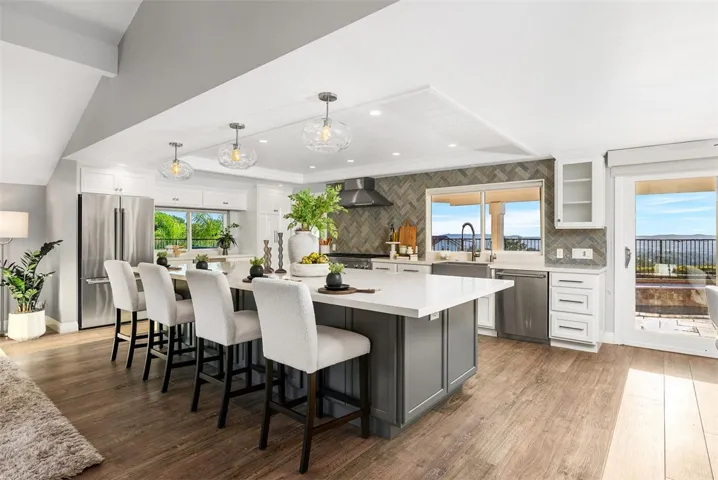 Massive 10' quartz island complete with generous storage and a dedicated wine and beverage fridge