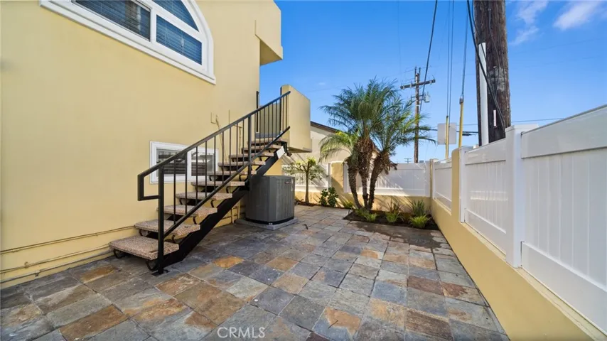 Rear Patio with stairs from family room balcony.