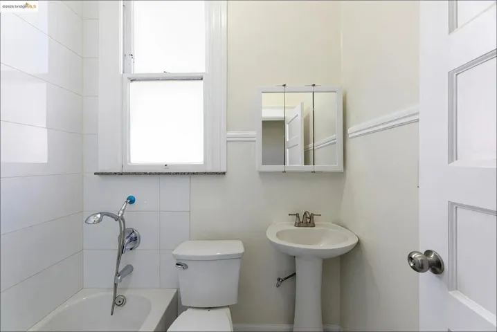 Full bath featuring a bath and toilet