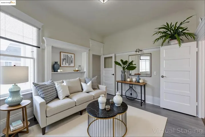 Virtually staged Living area with wood finished floors and baseboards