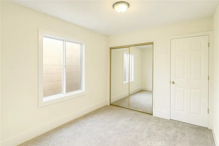 Front Bedroom 
Virtually edited – furniture digitally removed + lighting enhanced