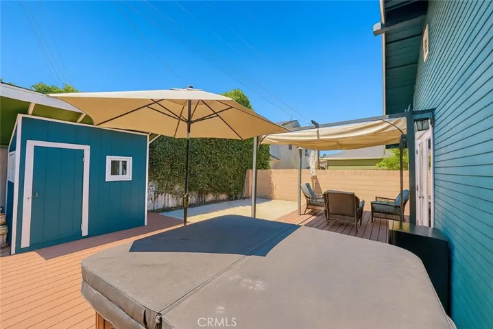 Back deck + patio area 
Virtually edited – fence digitally removed + lighting enhanced