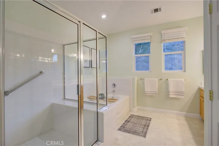 Primary ensuite bath with shower and soaking tub