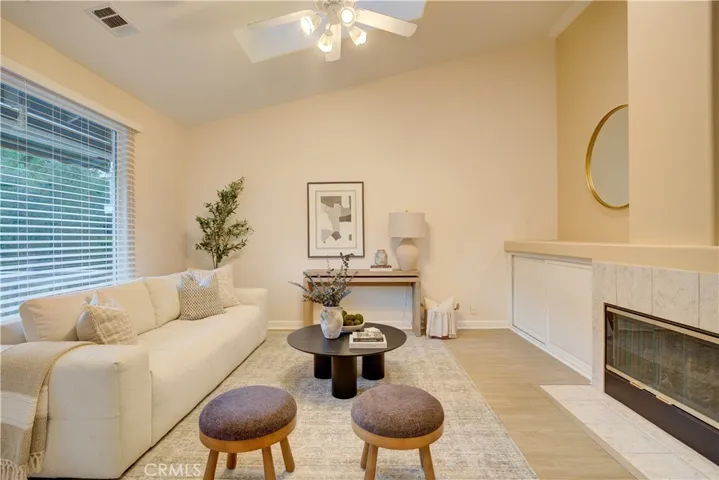 Main living area with cozy fireplace and backyard views