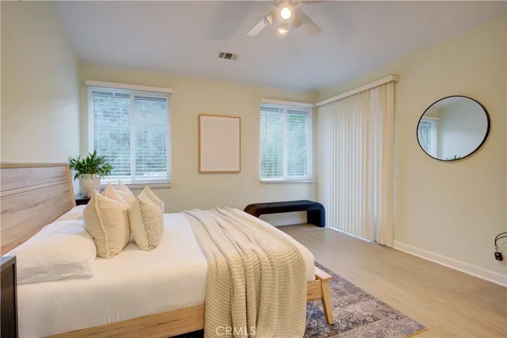 Primary bedroom with backyard views and sliding door to back deck