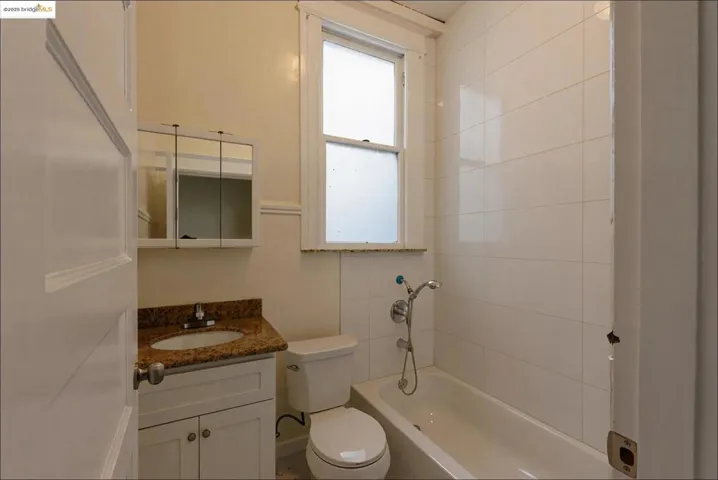 Empty Bathroom with vanity and shower / bath combination