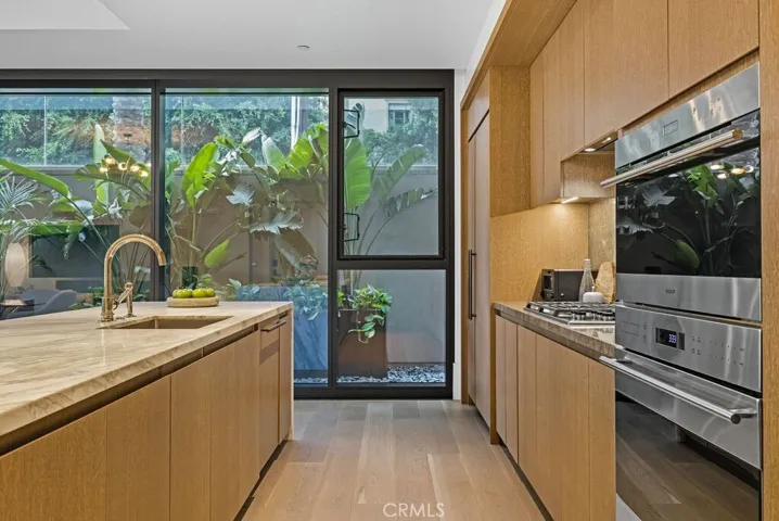Sleek kitchen with Sub-Zero integrated refrigerator, Wolf stove and more