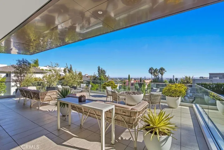 Upper outdoor patio with firepit and lounge areas
