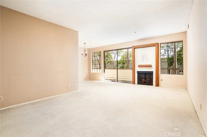 The living room has so much room for all your big furniture. The wall to the left can easily be removed opening up the kitchen to your future great room concept!