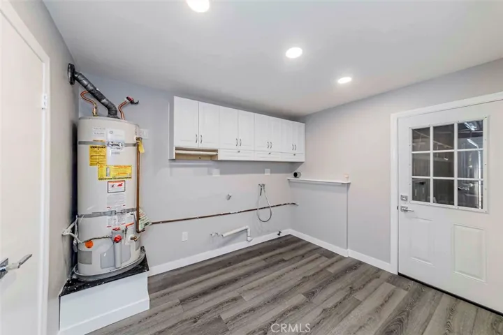 Laundry room with new storage cabinets. Access door to garage.