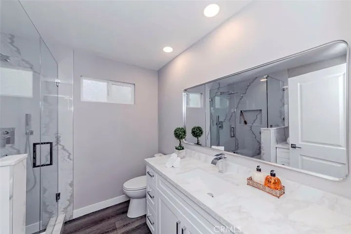 Downstairs bathroom has been totally remodeled, features a large shower with bench and storage cabinet.