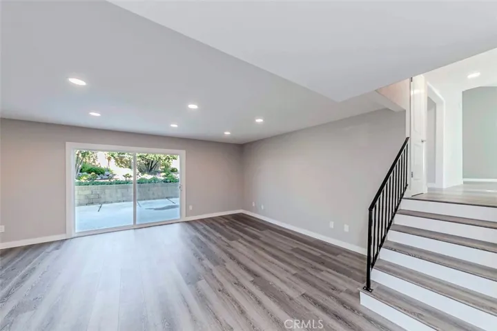 Downstairs great room feature recessed lighting and patio doors.