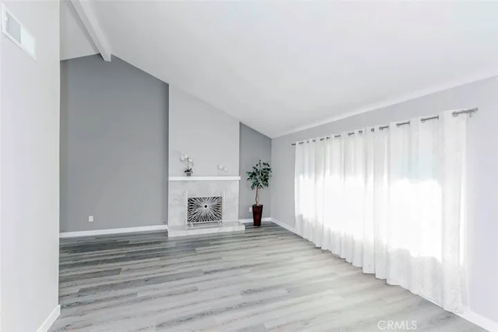 Living room feature vaulted ceilings and marble fireplace,
