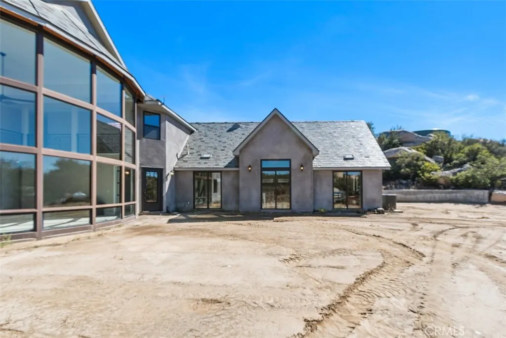 three sliding glass doors on the back side of the three car garage