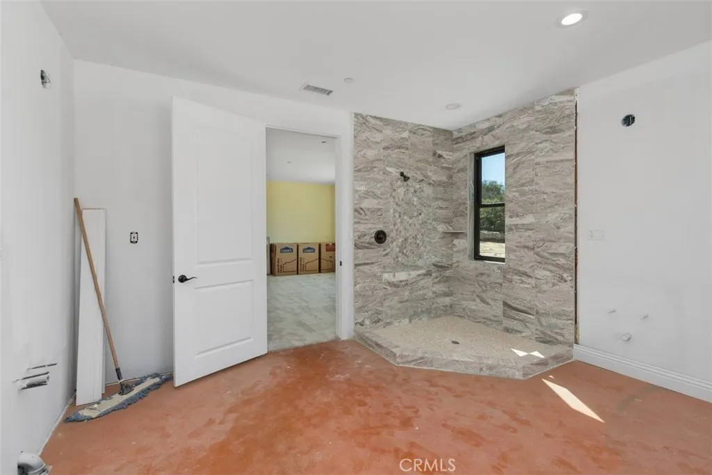 secondary bathroom needs flooring, cabinetry, counter tops, bathtub, sinks, toilet, light fixture and mirror. See virtually created photo for visual purposes only