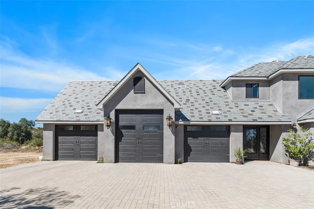 three car garage and partial pavers at side entry
