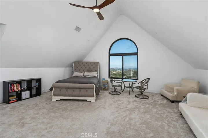 primary bedroom with vaulted ceilings
