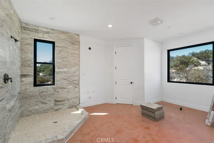 secondary bathroom needs flooring, cabinetry, counter tops, bathtub, sinks, toilet, light fixture and mirror. See virtually created photo for visual purposes only