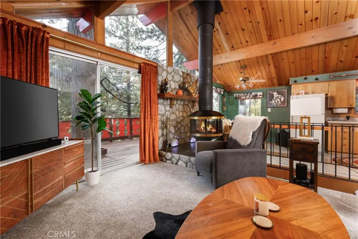 Unique fireplace and wall of windows in living area.