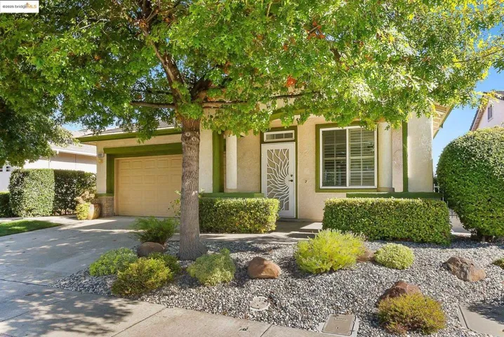 View of front of property featuring driveway and stucco siding