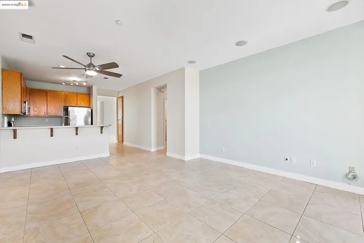Unfurnished living room with recessed lighting, light tile patterned floors, and a ceiling fan