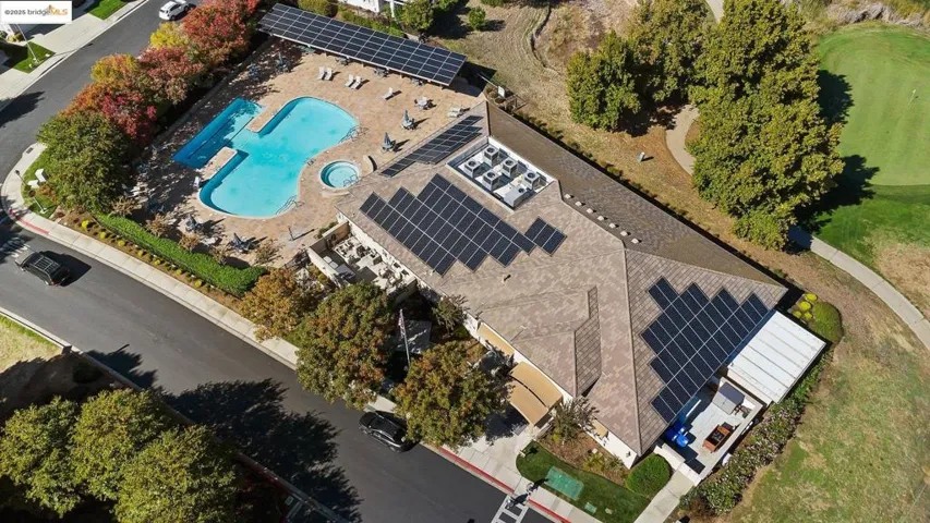 Aerial view of property and surrounding area with a pool area