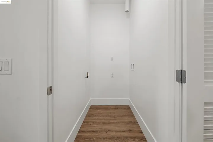 Laundry room featuring dark wood-style flooring and washer hookup
