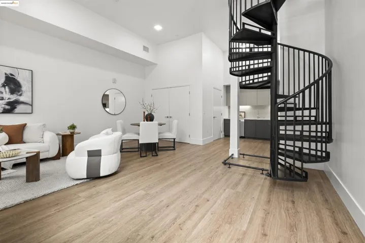 Foyer entrance featuring a high ceiling, light wood-style flooring, and stairs