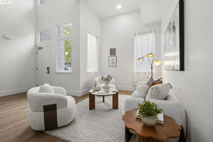 Living area with wood finished floors and a high ceiling
