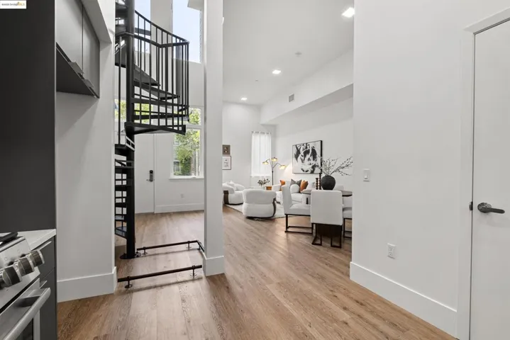 Entrance foyer featuring light wood finished floors, recessed lighting, stairway, and a high ceiling