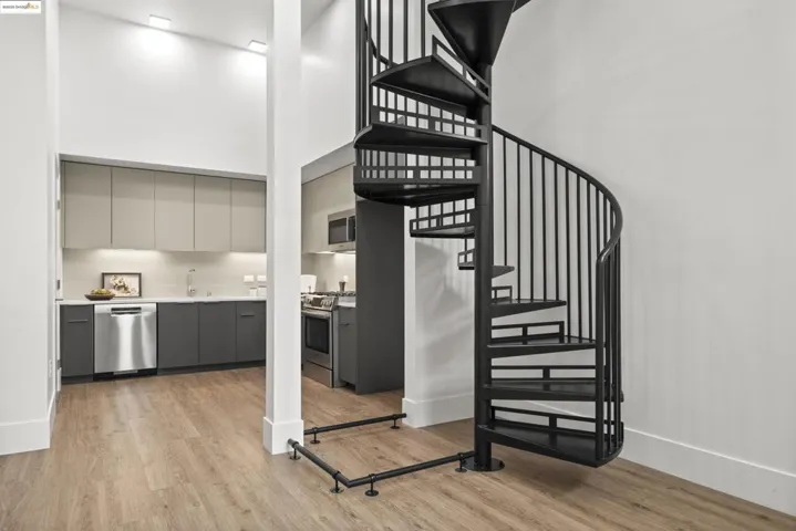 Stairs featuring a towering ceiling and wood finished floors