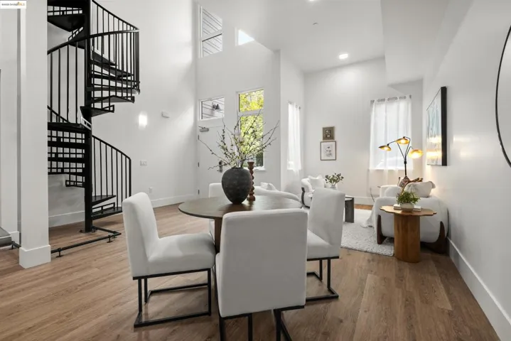 Dining space featuring a high ceiling, wood finished floors, stairway, and recessed lighting