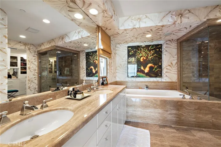 Spa-like master bath boasts dual sinks, jetted soaking tub, and walk-in shower. There is also a large walk-in closet with custom organizers.