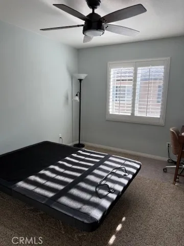 Second bedroom w/ hardwired lighted ceiling fan and shutters on dual pane window