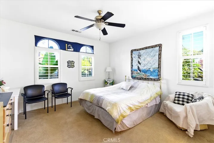 Guest room with platation shutters.
