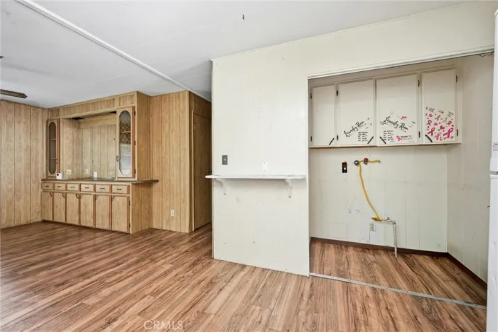 Laundry room conveniently located in closet in kitchen near the back door.