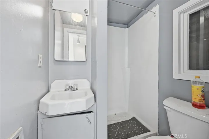 Bathroom in garage office space has a shower.