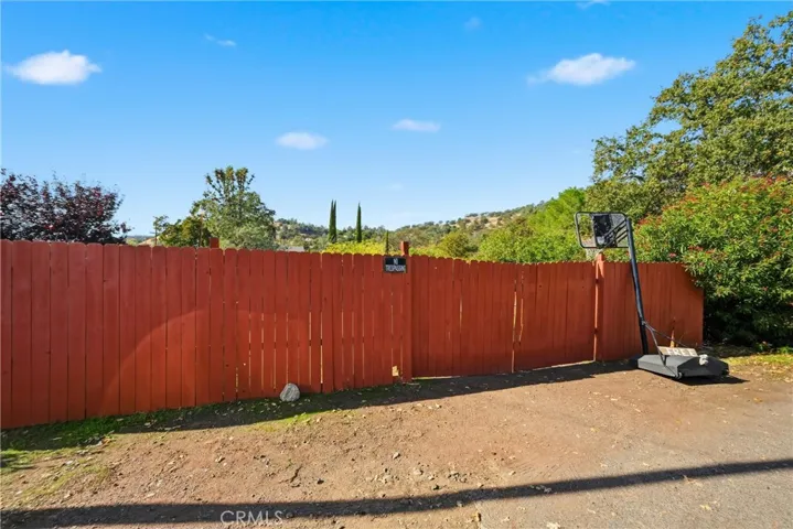 Fenced garage space has large opening for pulling in your toys.