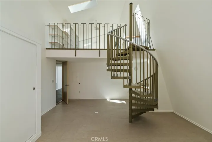 Main Level Bedroom 1 With Spiral Stairs To Bonus Room