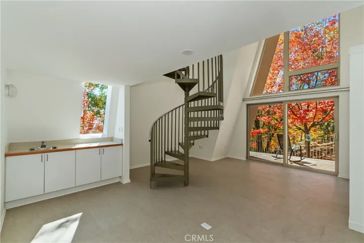 Main Level Bedroom 1 With Spiral Stairs To Bonus Room